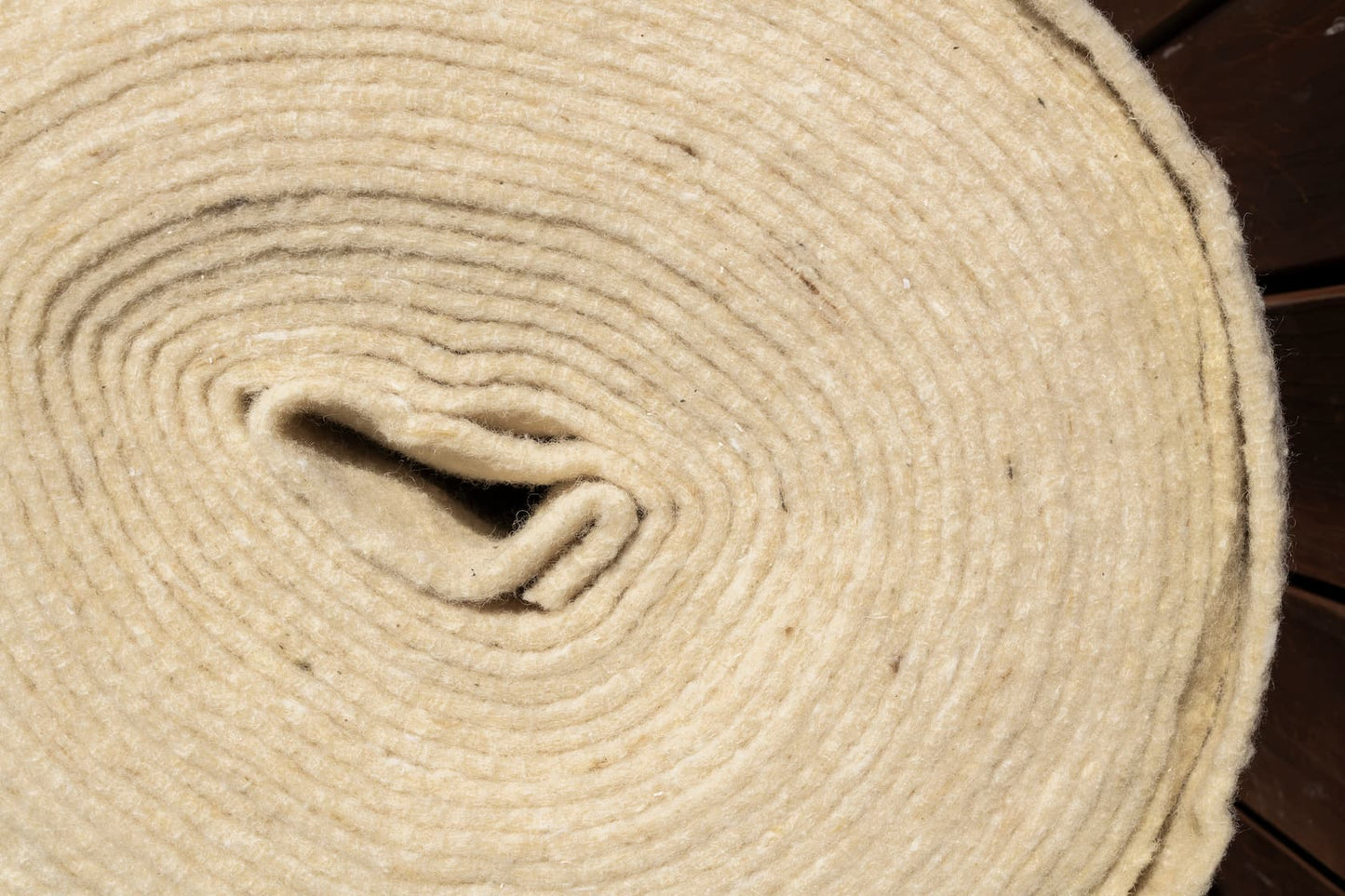 Wool mulch mat rolls laid in garden for weed control and moisture retention