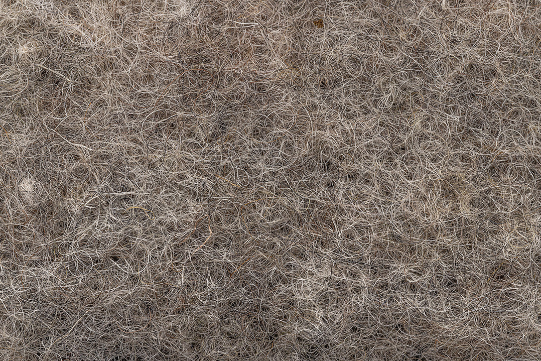 Roll of recycled wool mulch matting for eco-friendly garden weed control