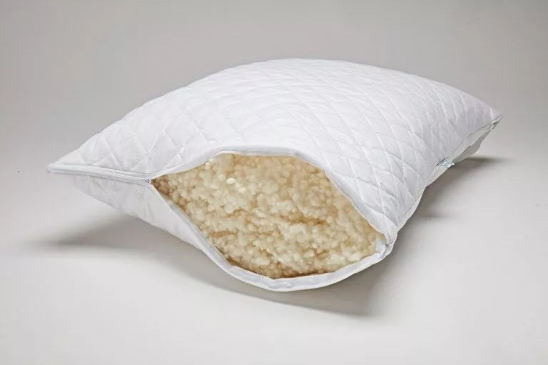 Wool.Life Sleep wool pillow on bed with natural wool fibres visible