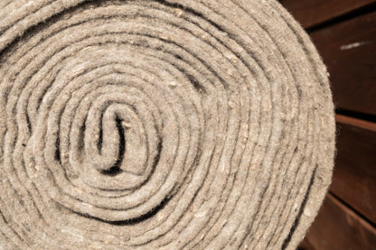 Close-up of recycled NZ wool mulch mat roll fibres - natural biodegradable weed mat texture