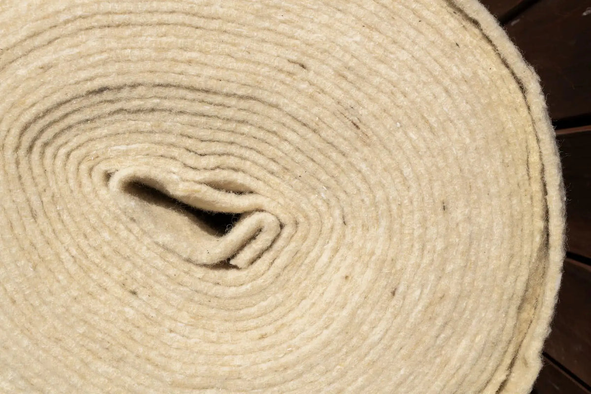 Wool.Life mulch mat rolls laid along garden path - weed control and moisture retention NZ