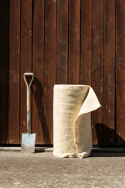 Garden bed covered with Wool.Life wool mulch mat rolls - supporting native NZ plants