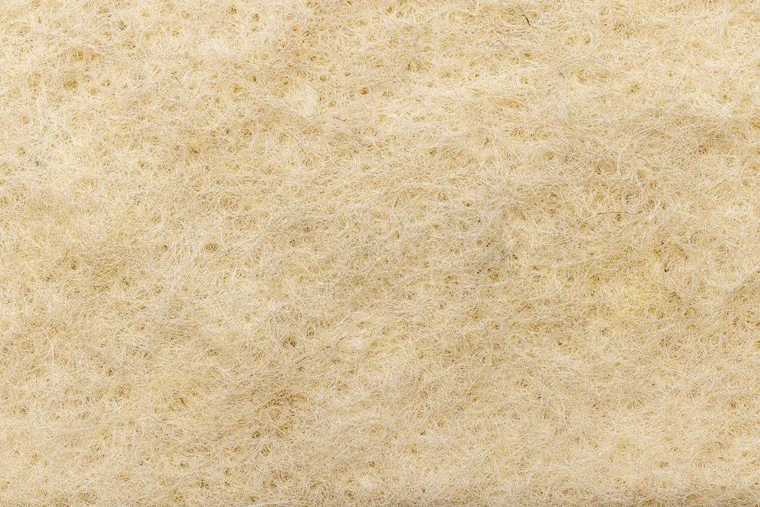 Wool mulch mat roll laid out for natural weed suppression and moisture